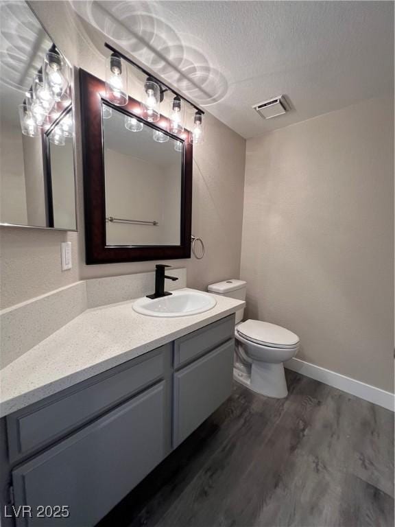 3238 Canyon Terrace Dr, Laughlin, NV 89029 - bathroom with wood finished floors, vanity, and a textured ceiling