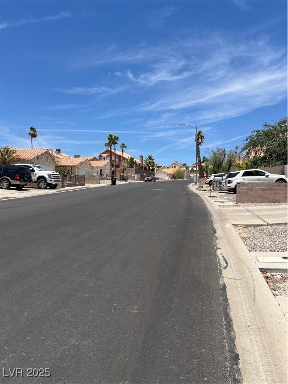 3238 Canyon Terrace Dr, Laughlin, NV 89029 - view of asphalt road featuring a residential view, street lights, and curbs