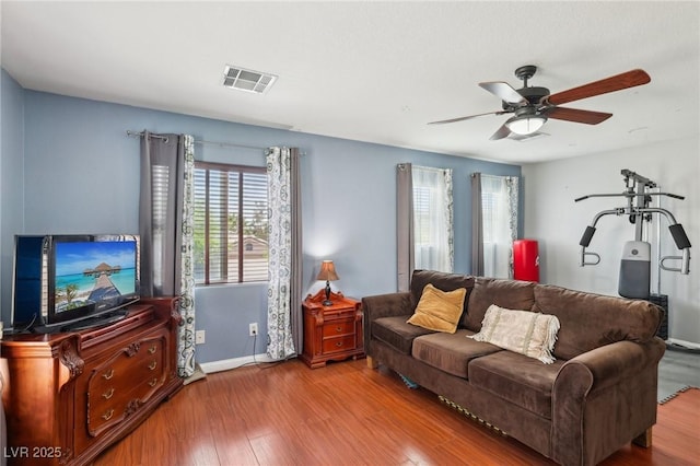 11620 Longhirst Hall Ln, Las Vegas, NV 89138 - living area with healthy amount of natural light, wood finished floors, and a ceiling fan