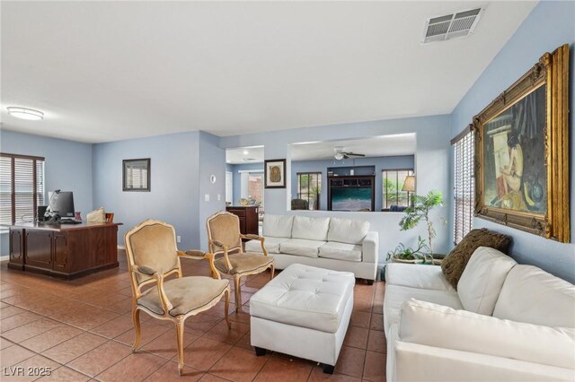 11620 Longhirst Hall Ln, Las Vegas, NV 89138 - tiled living area with a desk and ceiling fan