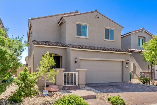 6313 Voss St, North Las Vegas, NV 89081 - mediterranean / spanish home with an attached garage, decorative driveway, stucco siding, and a tile roof