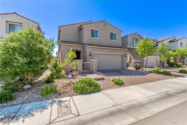 6313 Voss St, North Las Vegas, NV 89081 - mediterranean / spanish-style home with decorative driveway, a tiled roof, stucco siding, and a garage