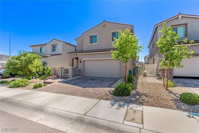 6313 Voss St, North Las Vegas, NV 89081 - mediterranean / spanish home featuring a gate, a tiled roof, driveway, stucco siding, and an attached garage
