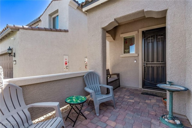 6313 Voss St, North Las Vegas, NV 89081 - doorway to property with stucco siding and a tile roof