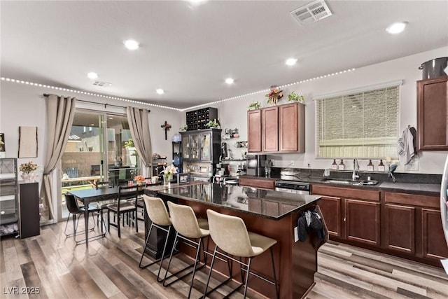 6313 Voss St, North Las Vegas, NV 89081 - kitchen with a kitchen breakfast bar, light wood-style flooring, a kitchen island, dishwashing machine, and recessed lighting
