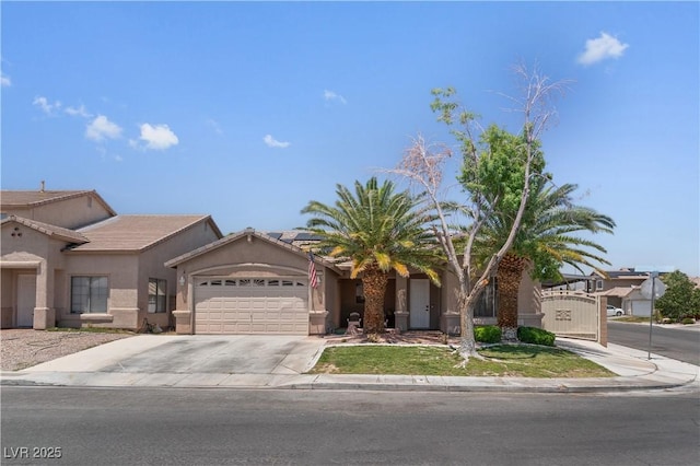 1310 Ripplestone Ave, North Las Vegas, NV 89081 - view of front facade with an attached garage, stucco siding, driveway, a tiled roof, and solar panels