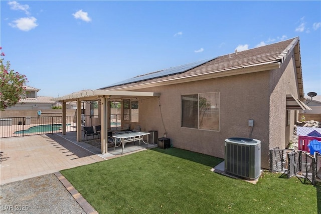 1310 Ripplestone Ave, North Las Vegas, NV 89081 - back of property with stucco siding, a fenced backyard, solar panels, and a patio