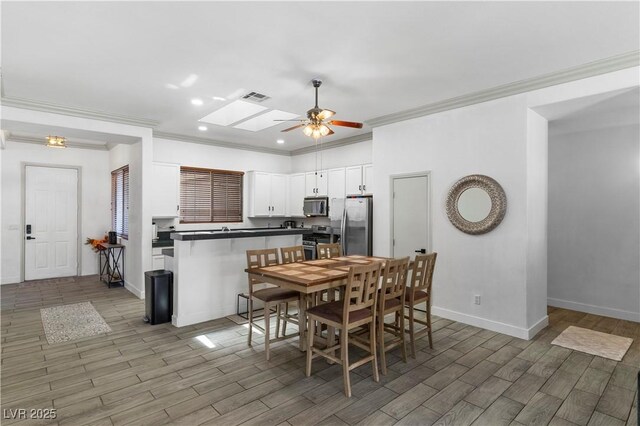 1310 Ripplestone Ave, North Las Vegas, NV 89081 - dining room with a ceiling fan, crown molding, recessed lighting, and light wood-style flooring
