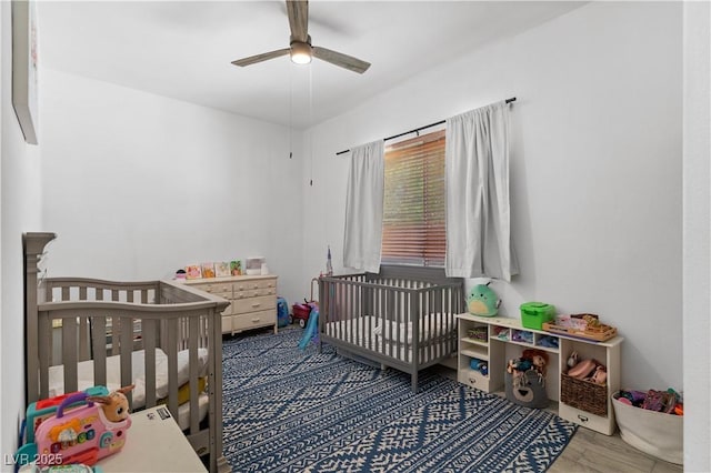 1310 Ripplestone Ave, North Las Vegas, NV 89081 - bedroom with a ceiling fan, a nursery area, and wood finished floors