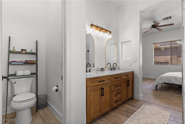 1310 Ripplestone Ave, North Las Vegas, NV 89081 - ensuite bathroom featuring wood finished floors, double vanity, and a ceiling fan