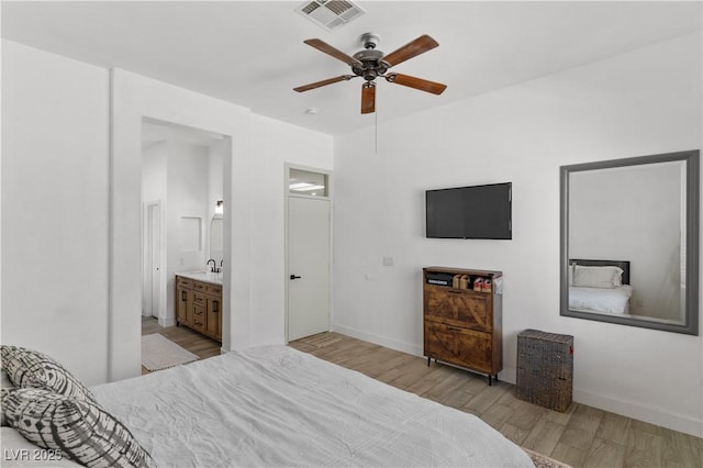 1310 Ripplestone Ave, North Las Vegas, NV 89081 - bedroom with light wood finished floors, connected bathroom, and a ceiling fan