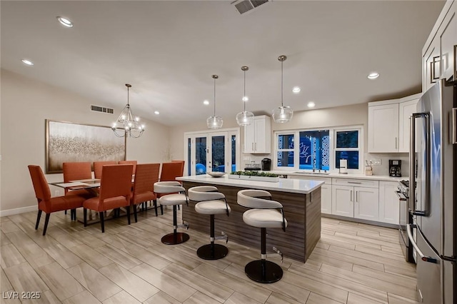 6316 Bluejay Way, Las Vegas, NV 89146 - kitchen with stainless steel appliances, light countertops, a center island, white cabinets, and recessed lighting