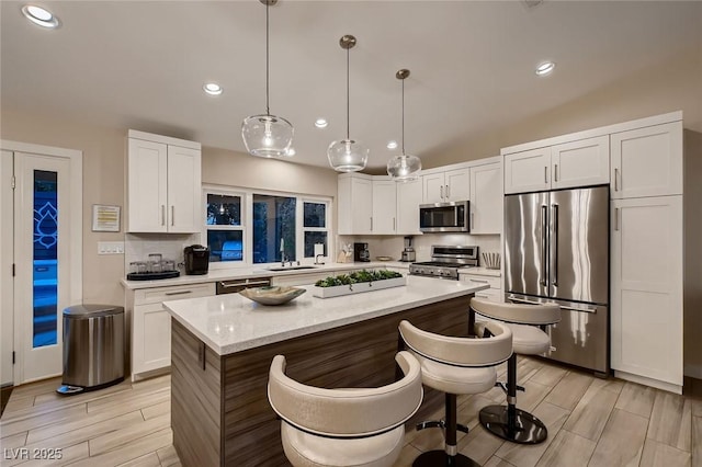 6316 Bluejay Way, Las Vegas, NV 89146 - kitchen with stainless steel appliances, white cabinets, a kitchen island, recessed lighting, and decorative backsplash