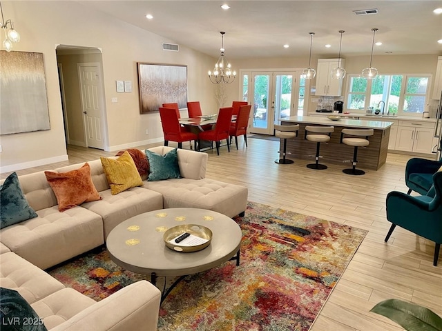 6316 Bluejay Way, Las Vegas, NV 89146 - living area featuring recessed lighting, light wood-style flooring, arched walkways, a chandelier, and french doors