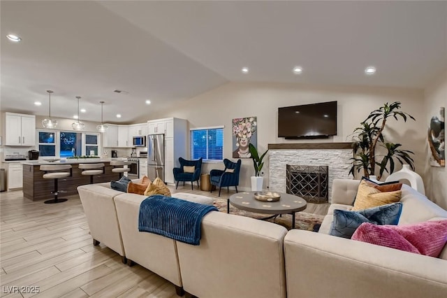 6316 Bluejay Way, Las Vegas, NV 89146 - living area with light wood-type flooring, vaulted ceiling, recessed lighting, and a fireplace