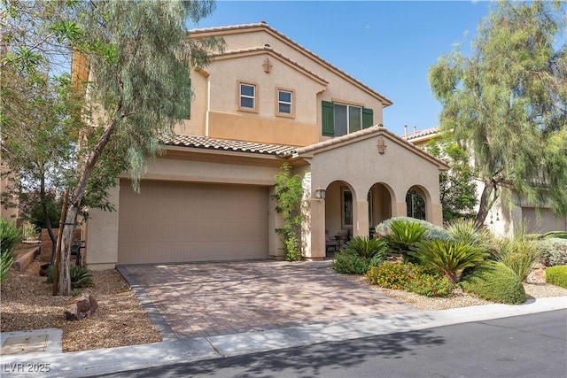 7854 Brianna Cheerful Ave, Las Vegas, NV 89178 - mediterranean / spanish home featuring stucco siding, decorative driveway, a tiled roof, and a garage