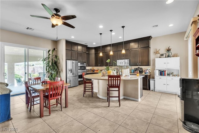 7854 Brianna Cheerful Ave, Las Vegas, NV 89178 - kitchen featuring appliances with stainless steel finishes, dark brown cabinets, light countertops, ceiling fan, and recessed lighting