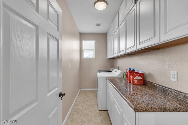 7854 Brianna Cheerful Ave, Las Vegas, NV 89178 - laundry area featuring washer and dryer, cabinet space, and light tile patterned floors
