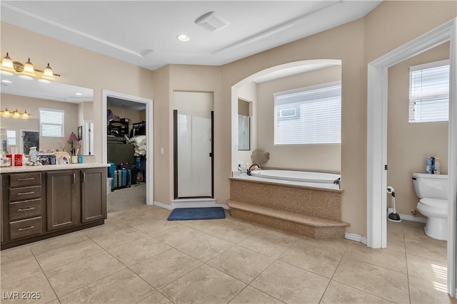 7854 Brianna Cheerful Ave, Las Vegas, NV 89178 - bathroom with vanity, a garden tub, a walk in closet, tile patterned flooring, and recessed lighting