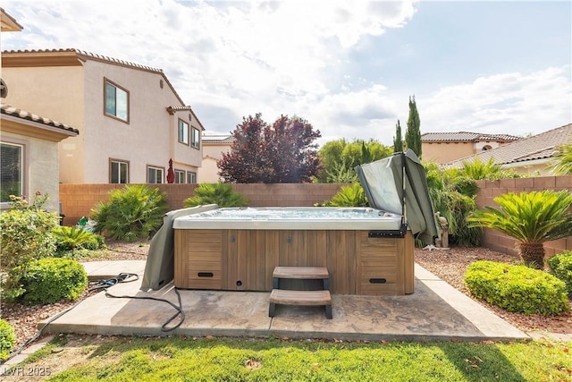 7854 Brianna Cheerful Ave, Las Vegas, NV 89178 - fenced backyard with a hot tub and a patio area