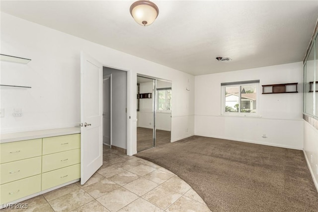 1393 Calmview Pl, Las Vegas, NV 89110 - unfurnished bedroom featuring light carpet, a closet, and light tile patterned floors