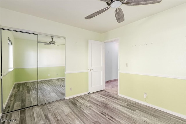 1393 Calmview Pl, Las Vegas, NV 89110 - unfurnished bedroom with wood finished floors, a closet, and a ceiling fan