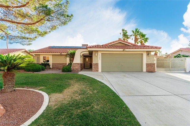 1393 Calmview Pl, Las Vegas, NV 89110 - mediterranean / spanish home featuring stucco siding, a garage, driveway, solar panels, and a tiled roof