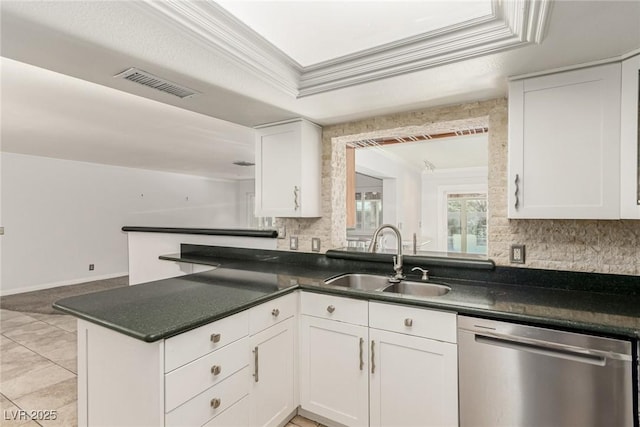 1393 Calmview Pl, Las Vegas, NV 89110 - kitchen featuring stainless steel dishwasher, tasteful backsplash, white cabinetry, a peninsula, and dark countertops