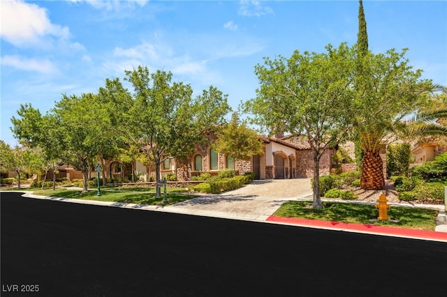 38 Pebble Dunes Ct, Las Vegas, NV 89141 - view of property hidden behind natural elements featuring stucco siding and curved driveway
