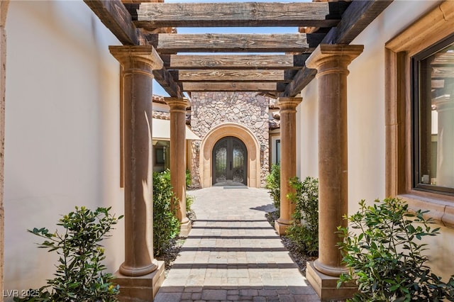 38 Pebble Dunes Ct, Las Vegas, NV 89141 - view of exterior entry with french doors, a pergola, and stone siding