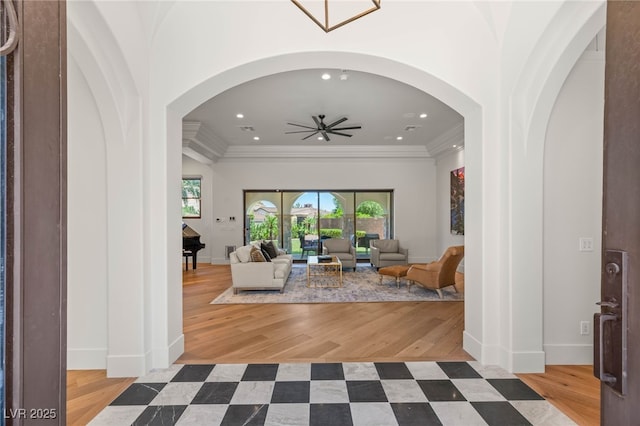 38 Pebble Dunes Ct, Las Vegas, NV 89141 - living room featuring crown molding, ceiling fan, recessed lighting, arched walkways, and wood finished floors