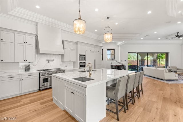 38 Pebble Dunes Ct, Las Vegas, NV 89141 - kitchen featuring appliances with stainless steel finishes, wall chimney range hood, light wood-style floors, recessed lighting, and decorative backsplash
