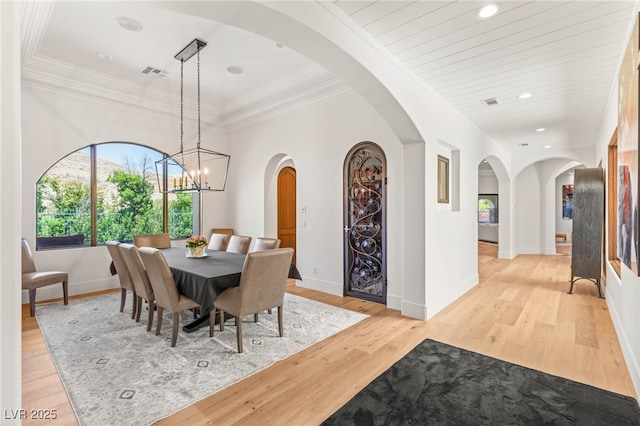 38 Pebble Dunes Ct, Las Vegas, NV 89141 - dining room featuring light wood finished floors, recessed lighting, crown molding, a chandelier, and arched walkways