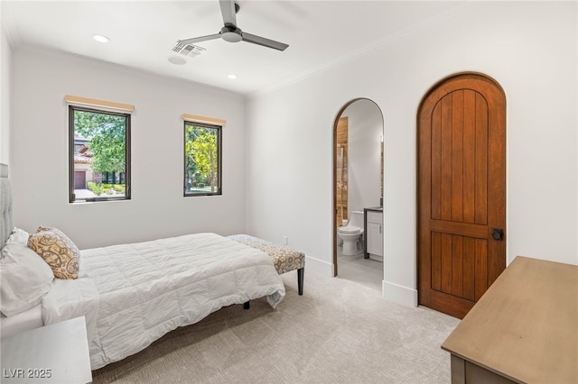 38 Pebble Dunes Ct, Las Vegas, NV 89141 - bedroom with ornamental molding, light colored carpet, recessed lighting, arched walkways, and connected bathroom
