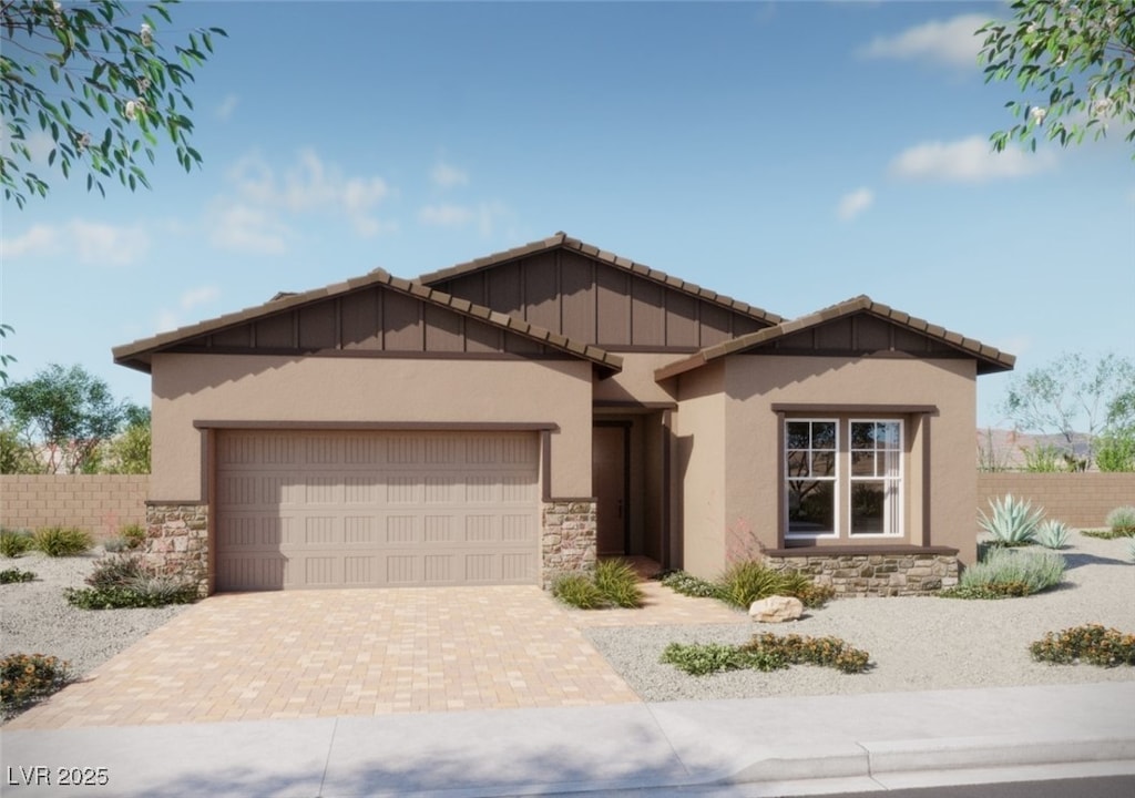 885 Cottonwood Hill Pl, Henderson, NV 89011 - view of front facade featuring stone siding, an attached garage, stucco siding, and decorative driveway