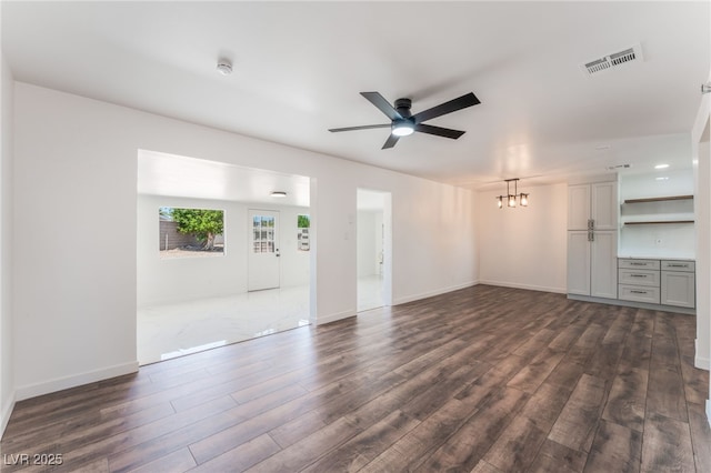 1313 Purple Sage Ave, Las Vegas, NV 89108 - unfurnished living room featuring dark wood-style floors, a ceiling fan, and a chandelier