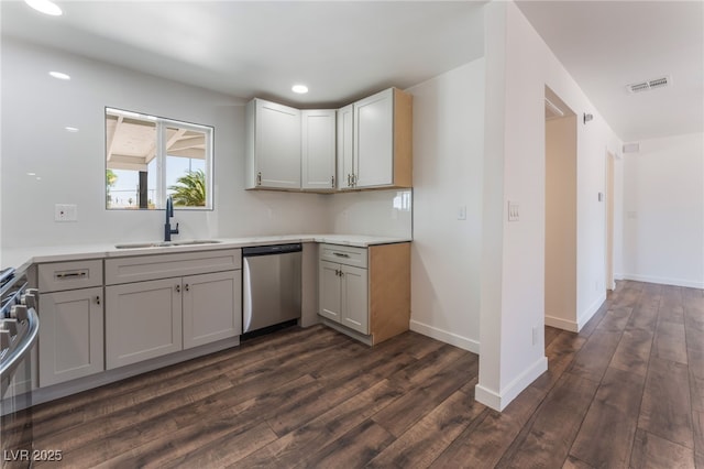 1313 Purple Sage Ave, Las Vegas, NV 89108 - kitchen with stainless steel appliances, dark wood-style flooring, light countertops, and recessed lighting