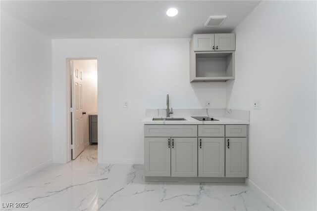 1313 Purple Sage Ave, Las Vegas, NV 89108 - kitchen with light marble finish flooring, gray cabinets, light countertops, and recessed lighting