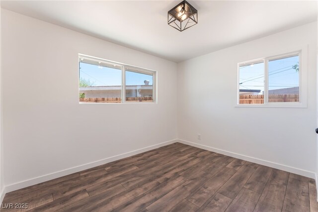 1313 Purple Sage Ave, Las Vegas, NV 89108 - empty room featuring plenty of natural light and dark wood-style floors