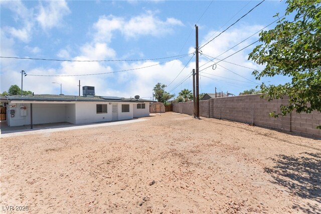 1313 Purple Sage Ave, Las Vegas, NV 89108 - back of property with a fenced backyard, roof mounted solar panels, and a patio area