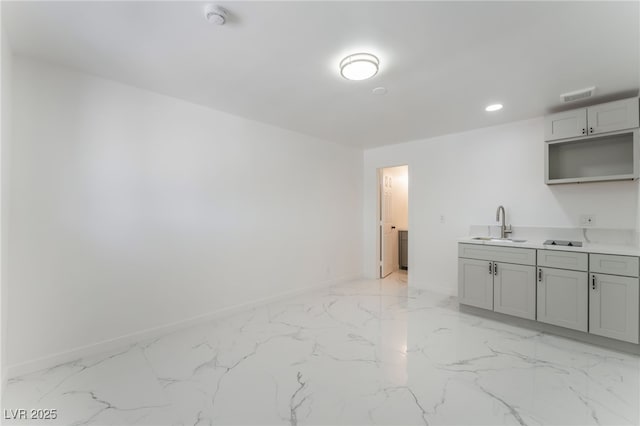 1313 Purple Sage Ave, Las Vegas, NV 89108 - kitchen featuring light marble finish floors, gray cabinets, recessed lighting, and light countertops