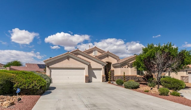 8204 Turbys Treehouse Pl, Las Vegas, NV 89131 - mediterranean / spanish-style home with stucco siding, driveway, an attached garage, stone siding, and a tiled roof