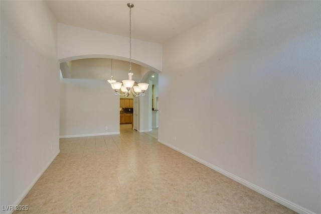 8204 Turbys Treehouse Pl, Las Vegas, NV 89131 - unfurnished room featuring arched walkways and a chandelier
