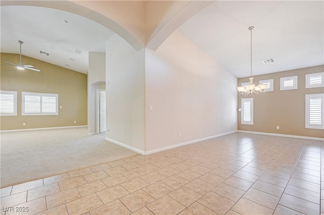 8204 Turbys Treehouse Pl, Las Vegas, NV 89131 - unfurnished room with light tile patterned floors, high vaulted ceiling, a ceiling fan, a chandelier, and light colored carpet
