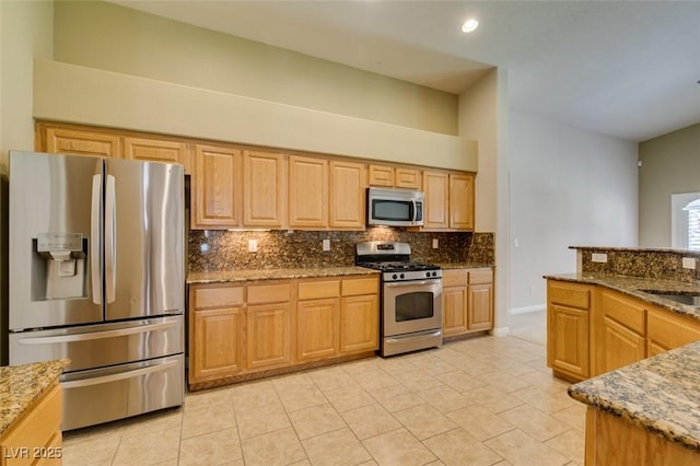 8204 Turbys Treehouse Pl, Las Vegas, NV 89131 - kitchen featuring appliances with stainless steel finishes, tasteful backsplash, stone counters, light tile patterned floors, and recessed lighting