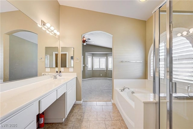 8204 Turbys Treehouse Pl, Las Vegas, NV 89131 - bathroom featuring ceiling fan, vanity, a garden tub, tile patterned flooring, and a stall shower