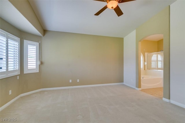 8204 Turbys Treehouse Pl, Las Vegas, NV 89131 - carpeted empty room featuring arched walkways and a ceiling fan