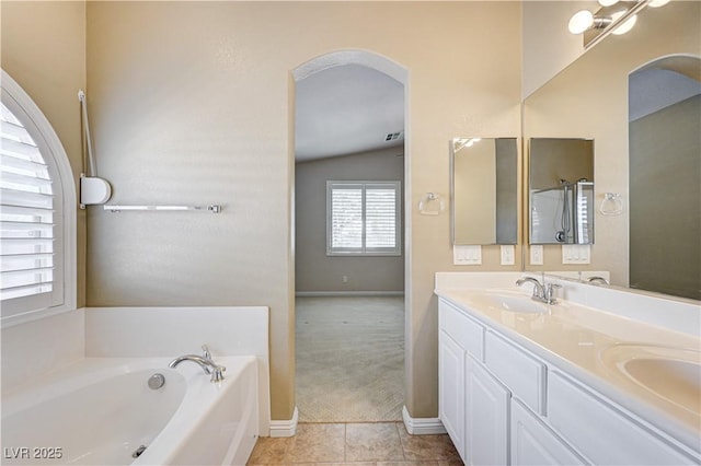 8204 Turbys Treehouse Pl, Las Vegas, NV 89131 - bathroom with double vanity, a garden tub, and tile patterned flooring