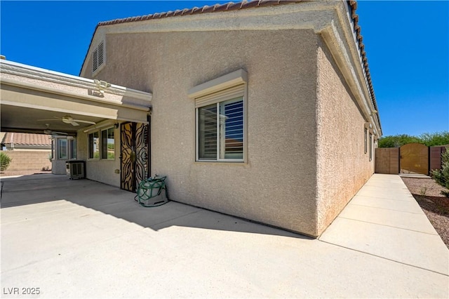 8204 Turbys Treehouse Pl, Las Vegas, NV 89131 - view of side of home featuring stucco siding, a gate, and a patio area