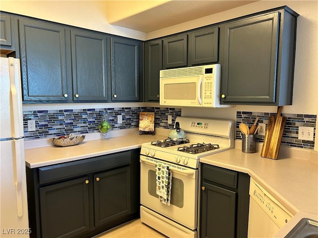 5855 Valley Dr Unit 2092, North Las Vegas, NV 89031 - kitchen with white appliances, decorative backsplash, and light countertops